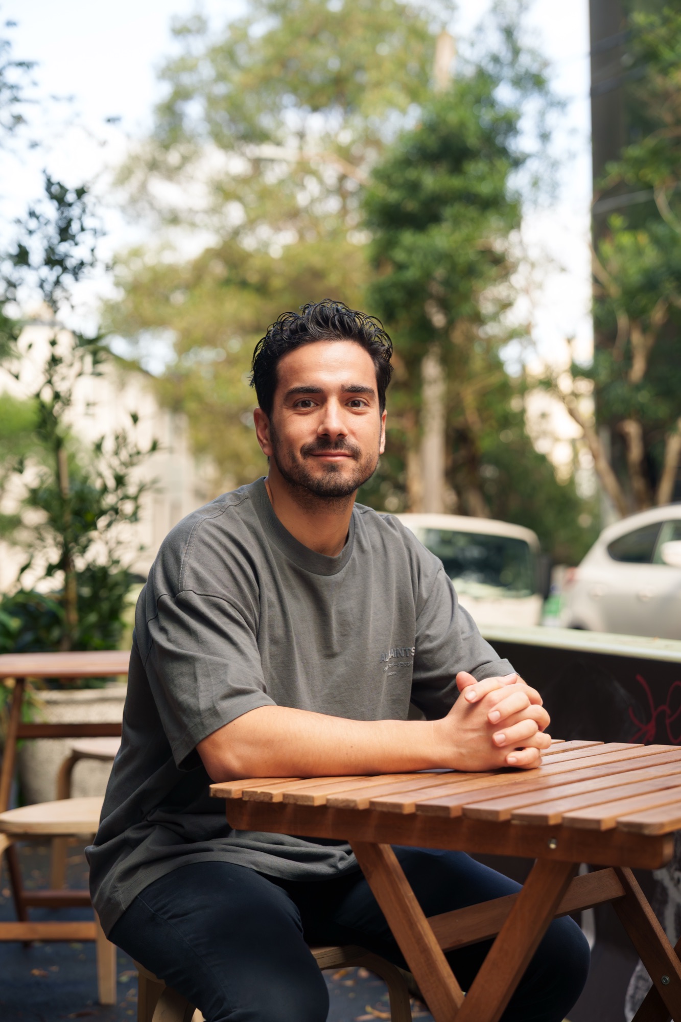Lambros Photios seated at an outdoor café table